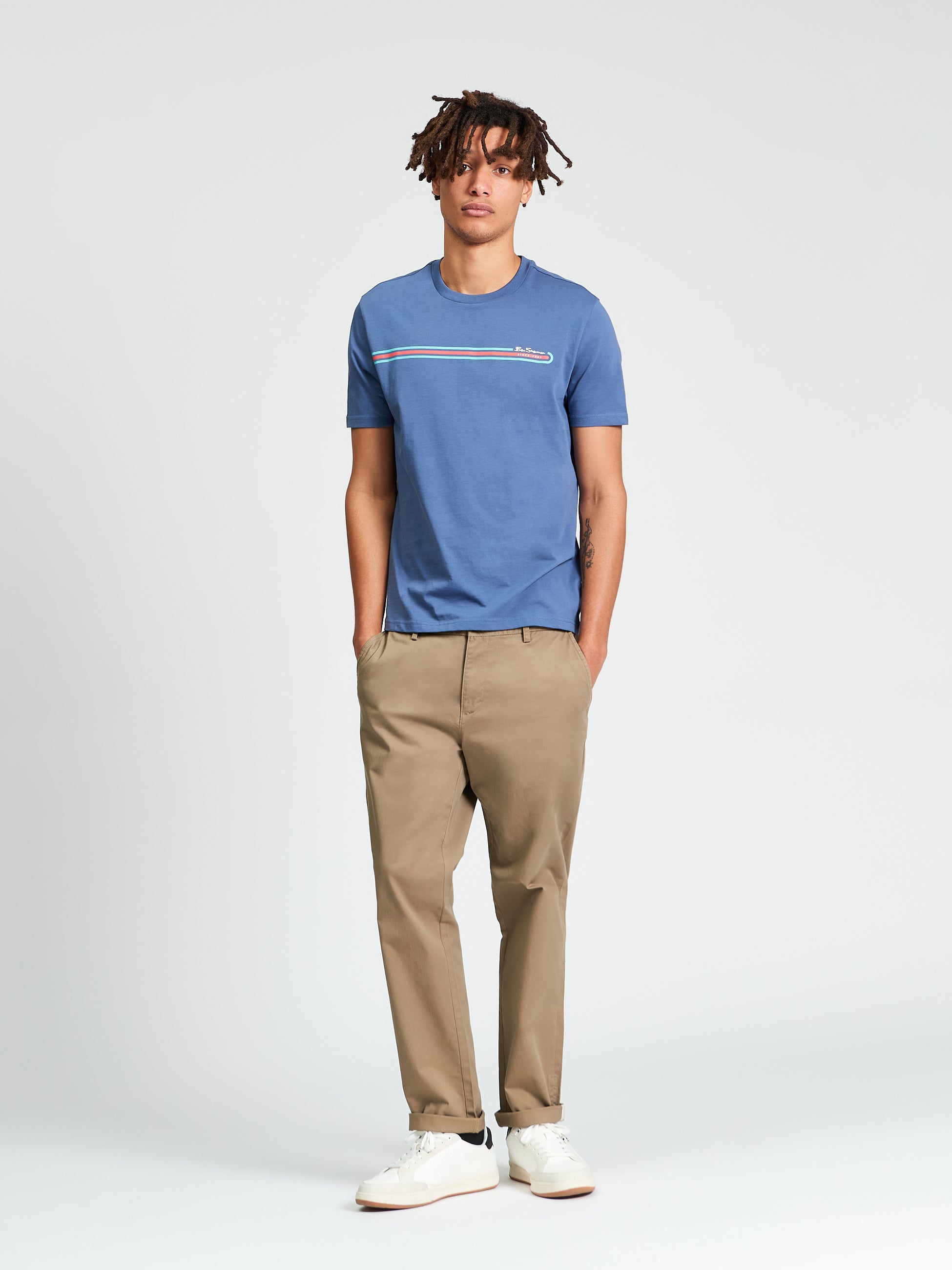 Core Stripe Tee worn by a model, featuring a printed chest stripe design and classic casual style.