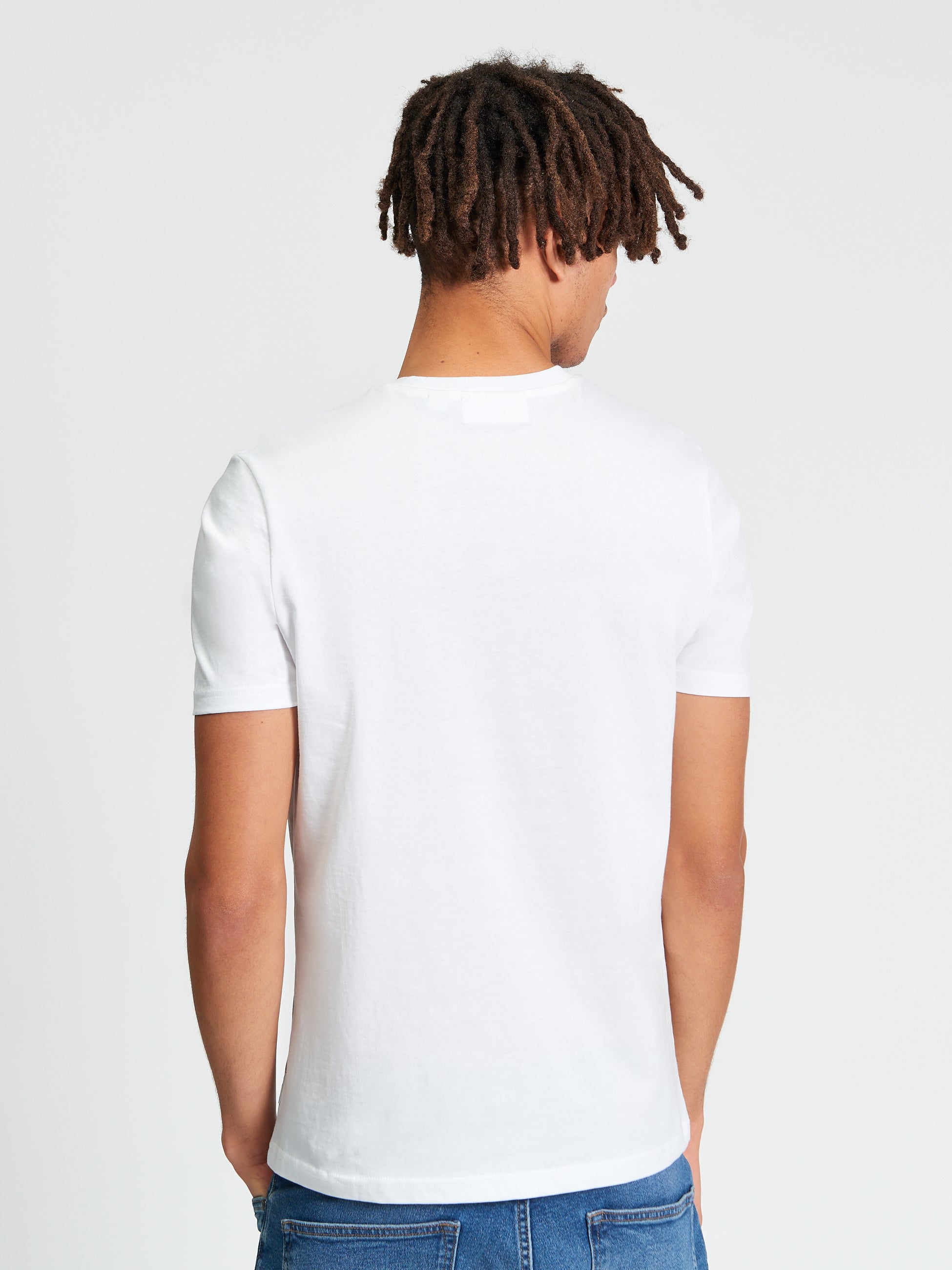 Back view of a man wearing a Plectrum Target Tee in white, showcasing the design and fit.