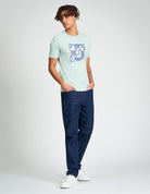 Model wearing Comic Target Tee featuring summer graphic print, paired with denim jeans and sneakers.