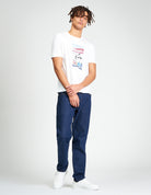 Post Card Tee – regular fit graphic t-shirt made from 100% organic cotton, styled with dark jeans and white sneakers.