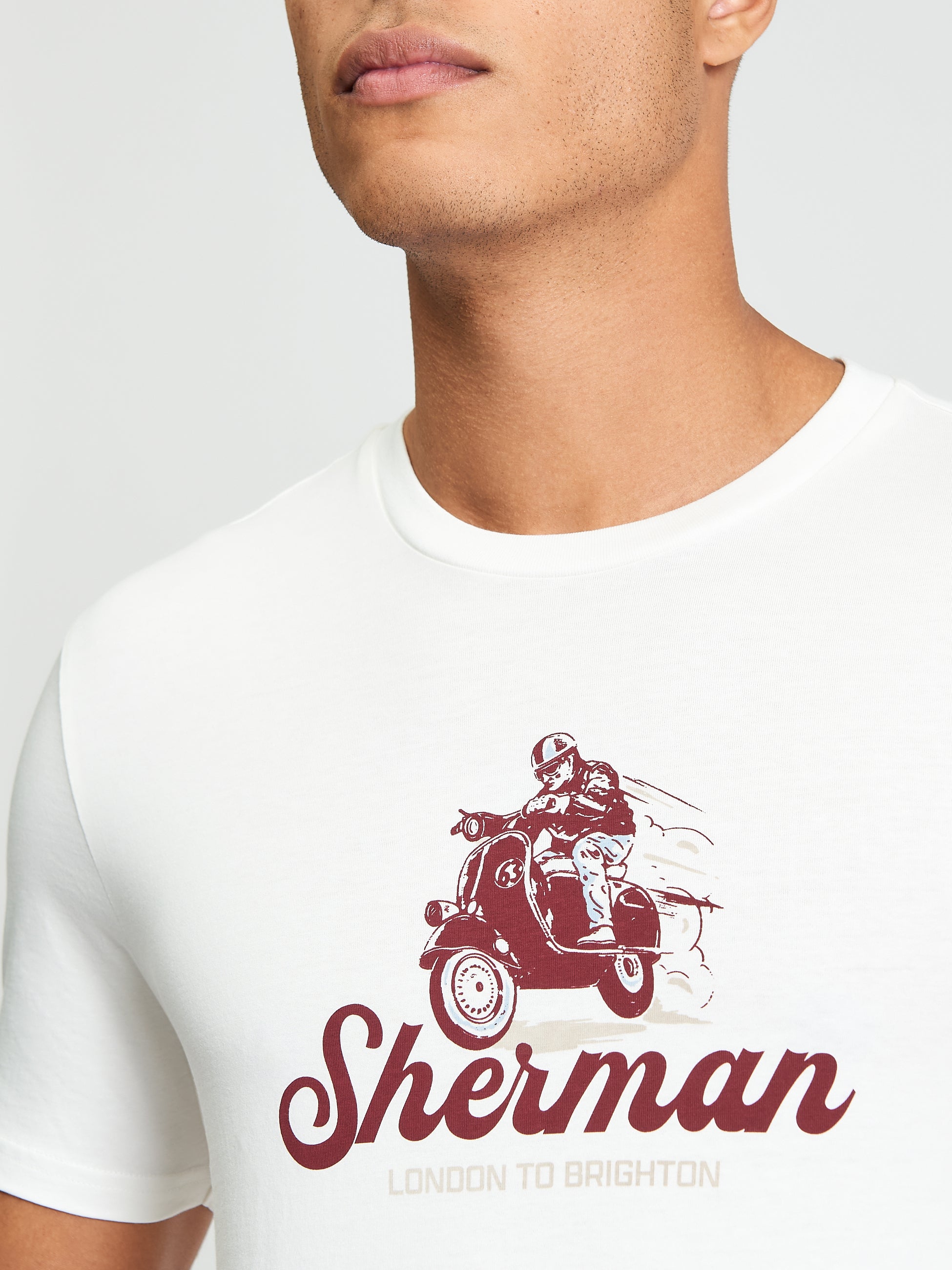 Close-up of Race Day Tee featuring mod-inspired print of a scooter and rider, highlighting Ben Sherman style.
