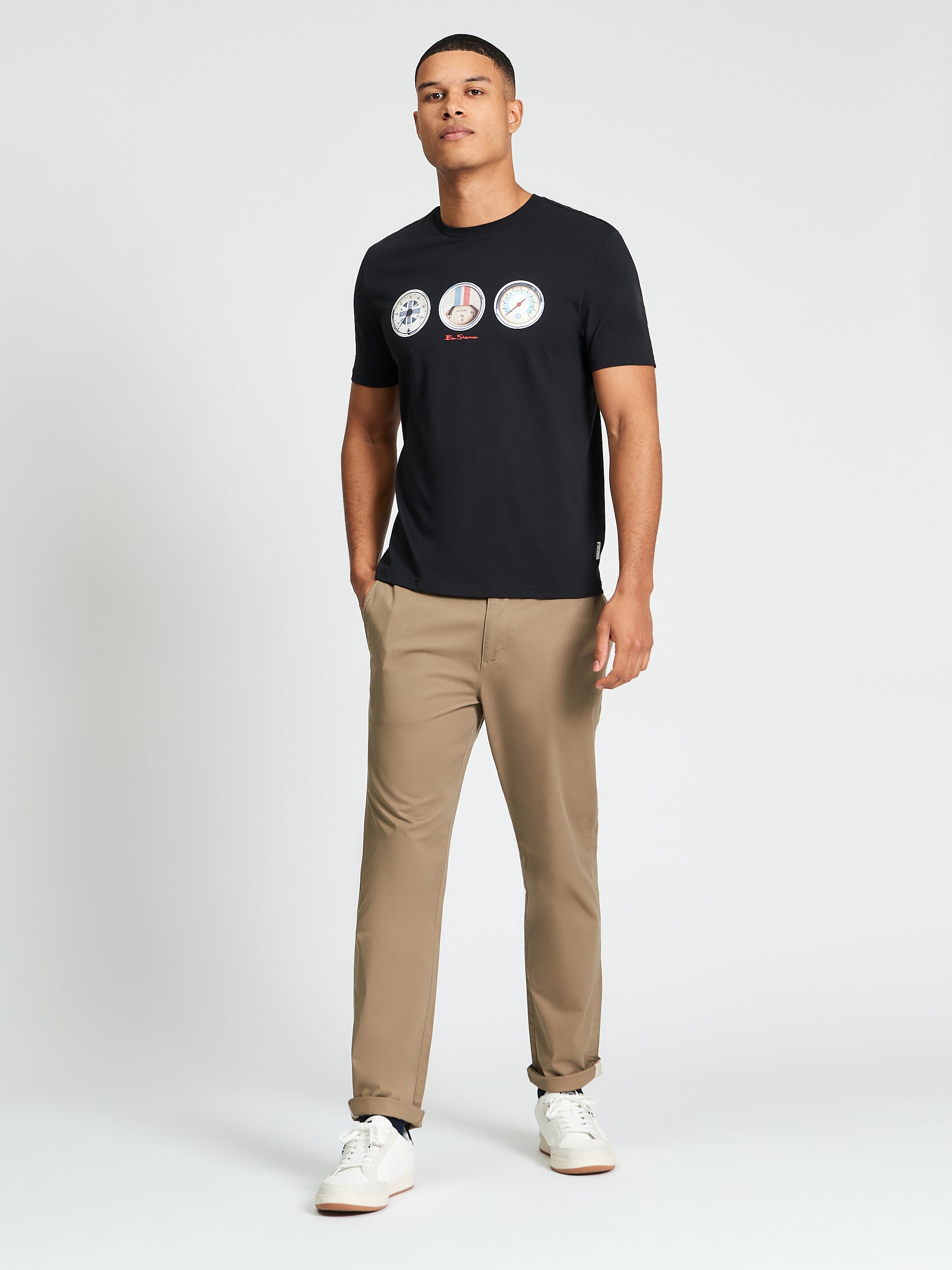 Speed Tee – black – featuring bold graphic print, styled with khaki pants and sneakers.