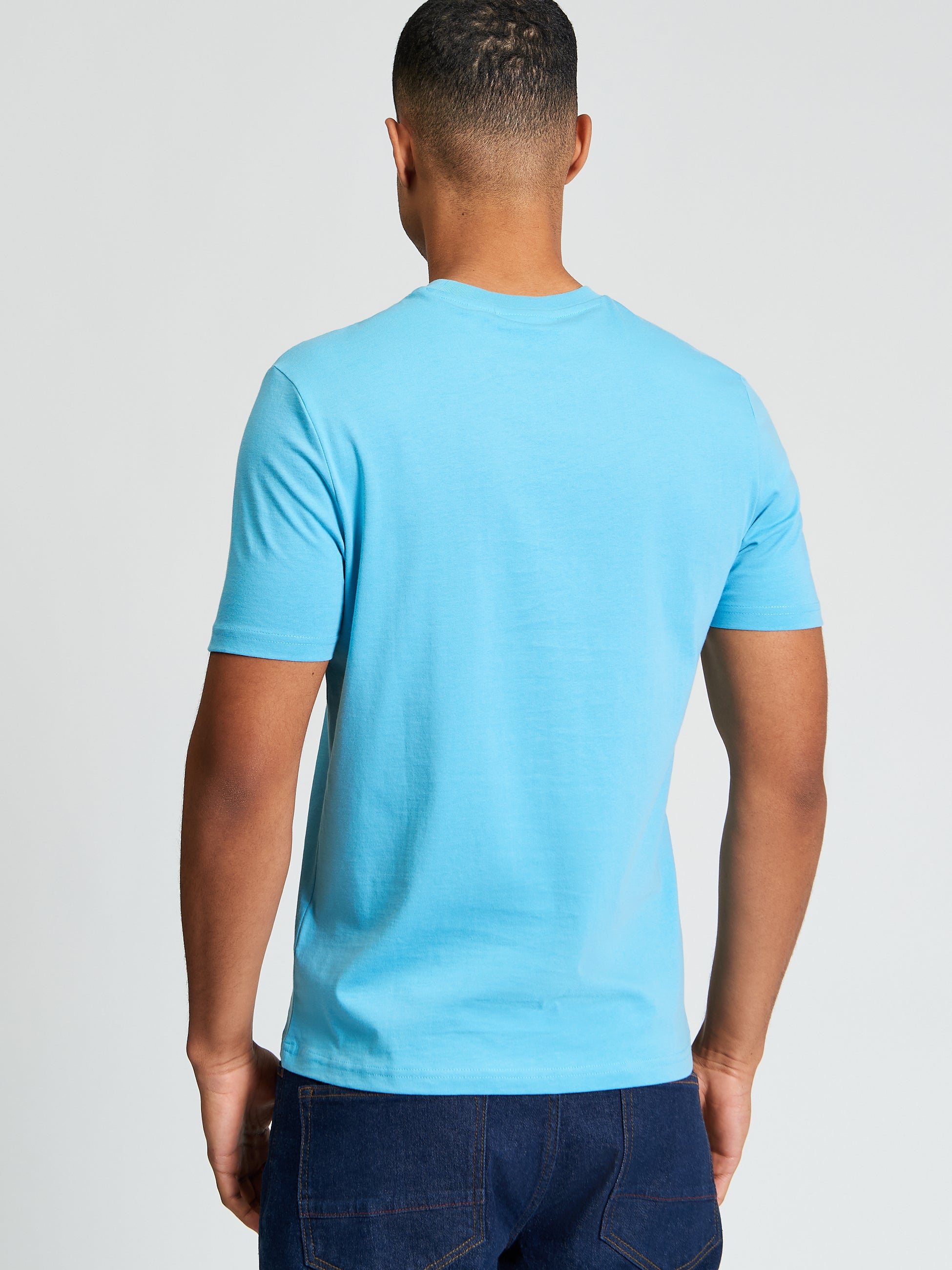 Signature Tee – Blue – Back view on model showcasing a comfortable and stylish fit.