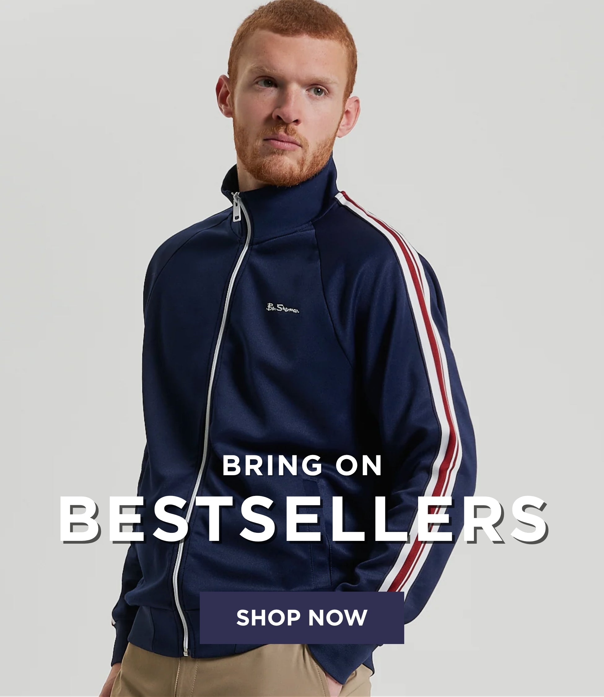 Man wearing the Ben Sherman House Tape Track Top in Dark Navy with white and red stripes, standing against a light gray background.